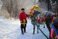 Man in Russian clothes with the decorated horse on a holiday of