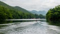 Man in traditional Thai boat going down river Royalty Free Stock Photo