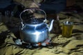 Man in traditional Tuareg outfit making tea in a desert Royalty Free Stock Photo