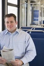 Man on train with newspaper Royalty Free Stock Photo