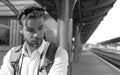 Man at the train station. Young man standing on platform at train station for travel