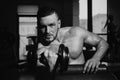 Man training with dumbbells. Dumbbell. Muscular guy exercises with dumbbells. Strong bodybuilder. Muscles with dumbbell. Royalty Free Stock Photo