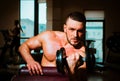 Man training with dumbbells. Dumbbell. Muscular guy exercises with dumbbells. Strong bodybuilder. Muscles with dumbbell. Royalty Free Stock Photo