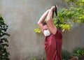 Man training his arms with protective mask and trx fitness straps in the park during the pandemic covid19 Royalty Free Stock Photo