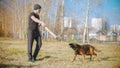 A man training his german shepherd dog on the field - incite the dog on the grip bait