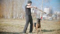 A man training his german shepherd dog - incite the dog on the grip bait and making the dog jump