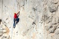 A man is training to climb on a rock.