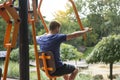 Man trains on the outdoors training apparatus of the open air gym Royalty Free Stock Photo