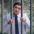Man trapped in prison with dollars Royalty Free Stock Photo