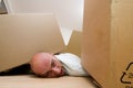 Man trapped under boxes Royalty Free Stock Photo