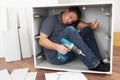 Man Trapped Whilst Assembling Flat Pack Furniture Royalty Free Stock Photo