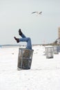 Man in Trash on Beach