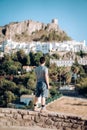 Man in travel, Asian man standing on the edge, looking at the old city, Zahara de la Sierra in Cadiz, Spain Royalty Free Stock Photo