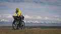 The man travel on mixed terrain cycle touring with bikepacking. The traveler journey with bicycle bags. Sport tourism