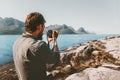 Man travel photographer blogger with camera taking photo of mountains