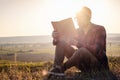 Man travel relax in the holiday. seats relax read books on rocky cliffs Royalty Free Stock Photo