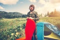 Man Traveler bearded preparing camping equipment mattress and tent outdoor