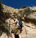 Man traveler climbing up a stepped mountain road. Spain