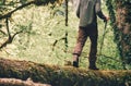 Man Traveler crossing over river on woods outdoor