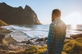 Man traveler enjoying Kvalvika beach ocean view travel lifestyle