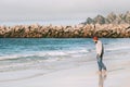 Man traveler enjoying ocean view on empty beach Royalty Free Stock Photo