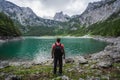 Man traveler enjoying view of Dachstein peak mountains on a Upper Gosau Lake. Gosau, Salzkammergut, Austria, Europe Royalty Free Stock Photo