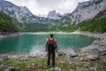 Man traveler enjoying view of Dachstein peak mountains on a Upper Gosau Lake. Gosau, Salzkammergut, Austria, Europe Royalty Free Stock Photo