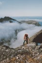 Man traveler hiking above clouds in mountains travel active lifestyle climbing solo Royalty Free Stock Photo