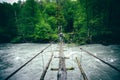 Man Traveler hiking on wooden bridge over river Royalty Free Stock Photo