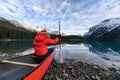 Man traveler holding paddle on red canoe in Spirit Island on Maligne lake at Jasper national park Royalty Free Stock Photo