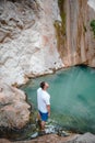 man traveler looking at dimosari waterfall lake at summer time Royalty Free Stock Photo
