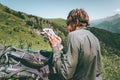 Man Traveler with map route find way to hike in mountains Travel Lifestyle adventure Royalty Free Stock Photo