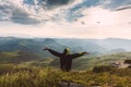 Man Traveler on mountain summit enjoying aerial view hands raised Travel Lifestyle success concept adventure active vacations Royalty Free Stock Photo