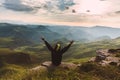 Man Traveler on mountain summit enjoying aerial view hands raised Travel Lifestyle success concept adventure active vacations Royalty Free Stock Photo