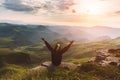 Man Traveler on mountain summit enjoying aerial view hands raised Travel Lifestyle success concept adventure active vacations Royalty Free Stock Photo