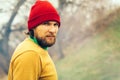 Man Traveler portrait beard face and hat alone in forest