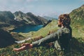 Man traveler raised hands enjoying blue lake in mountains aerial view Royalty Free Stock Photo