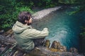 Man Traveler relaxing on wooden bridge