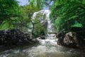 Man traveler is sightseeing at khlong lan waterfall in Kamphengphet Royalty Free Stock Photo