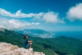 Man traveler sitting on mountain and looking at beautiful landscape and sea Royalty Free Stock Photo