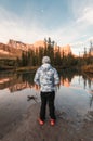 Man traveler standing enjoy the scenery of Three Sisters Mountains reflection on river in autumn at morning Royalty Free Stock Photo