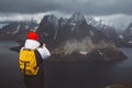 Man traveler taking photo with a smartphone hiking on Reinebringen mountain ridge in Norway lifestyle adventure traveling Royalty Free Stock Photo