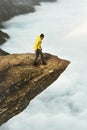 Man traveler on Trolltunga rocky cliff edge mountains Royalty Free Stock Photo