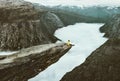 Man traveler on Trolltunga rocky cliff edge in Norway Royalty Free Stock Photo