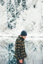 Man Traveler walking alone lake and forest winter Royalty Free Stock Photo