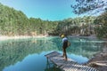 Man traveler walking alone to blue lake in woods Royalty Free Stock Photo