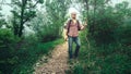 Man traveler walks along a path through a mountain forest. Travel lifestyle