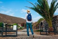 Man traveler walks along road in Akrotiri village on Santorini island Greece. Tourist backpacker admires view Royalty Free Stock Photo