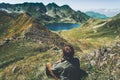 Man traveler wander blue lake in mountains aerial view