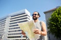 Man traveling with backpack and map in city Royalty Free Stock Photo